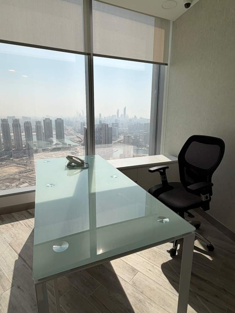 Desk with skyline view at Addax Tower